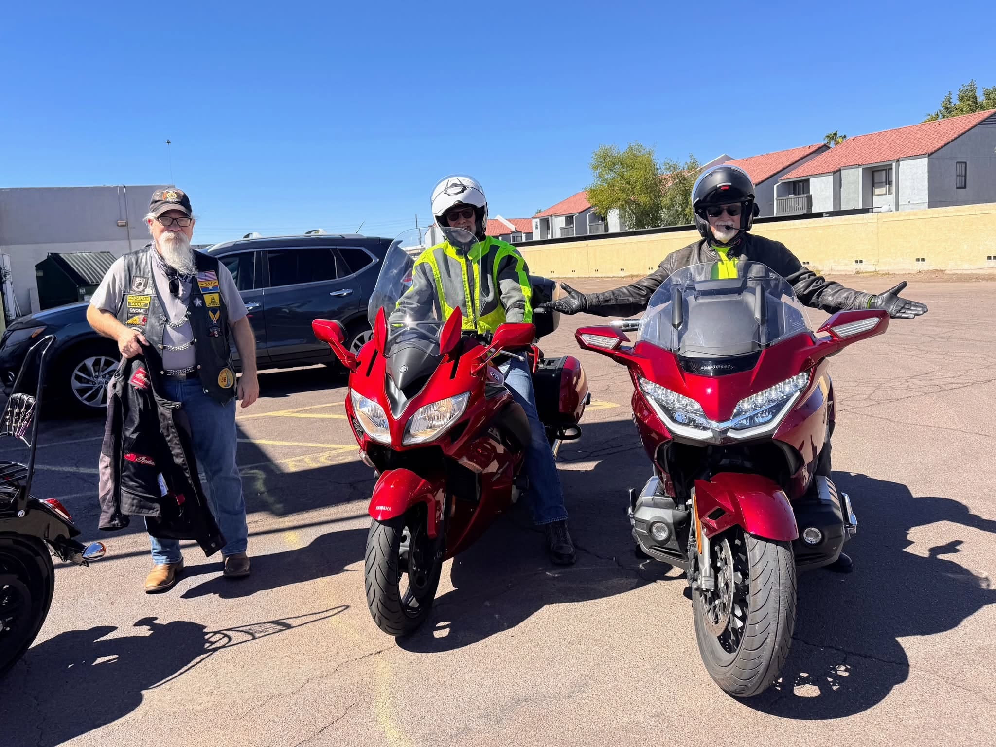 ALR riders with red motorcycles in parking lot